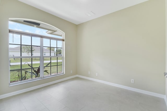 spare room featuring light tile patterned floors