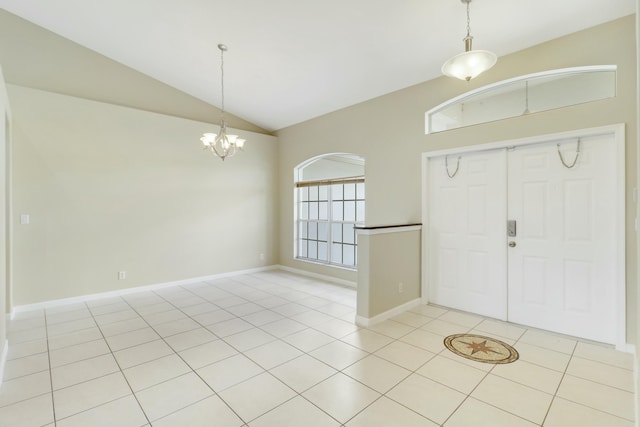 tiled entryway with lofted ceiling and a notable chandelier