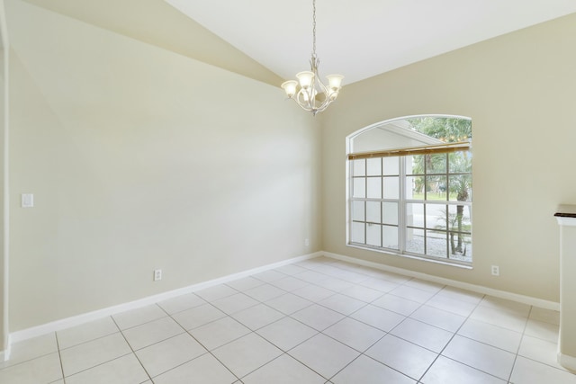 tiled spare room with vaulted ceiling and a notable chandelier