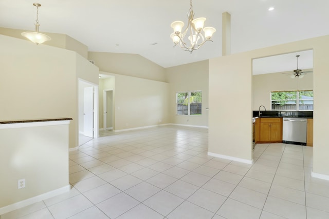 tiled empty room featuring ceiling fan with notable chandelier, high vaulted ceiling, and sink