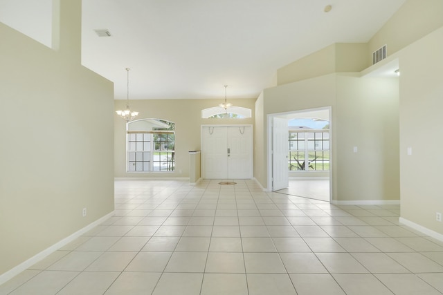 tiled entrance foyer with an inviting chandelier