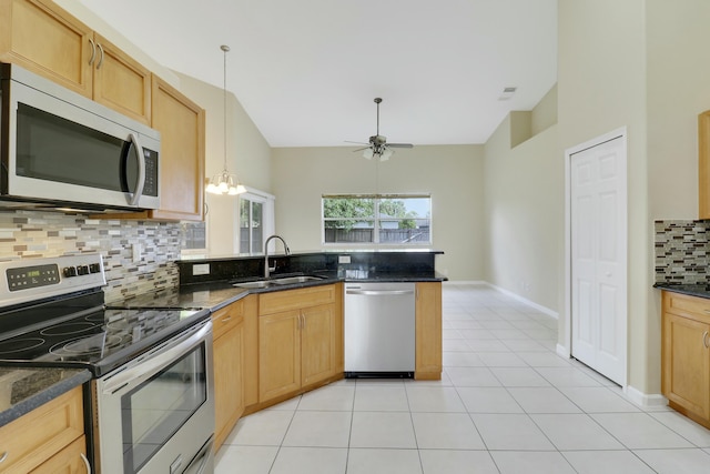 kitchen with appliances with stainless steel finishes, backsplash, ceiling fan with notable chandelier, sink, and light tile patterned floors