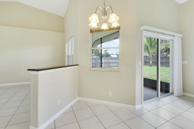 unfurnished dining area with high vaulted ceiling, plenty of natural light, a notable chandelier, and light tile patterned flooring