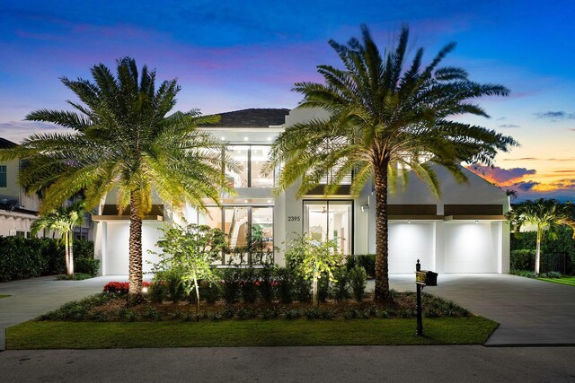 view of front of property with a garage and a balcony