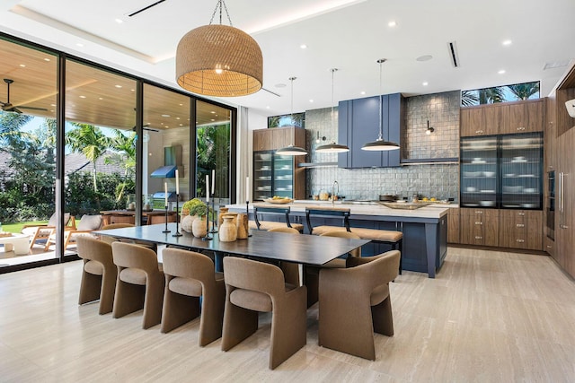 dining area with light wood-type flooring and floor to ceiling windows