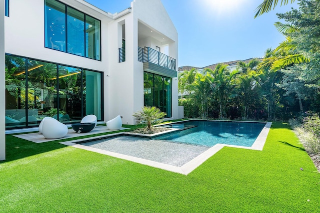 view of pool with a lawn