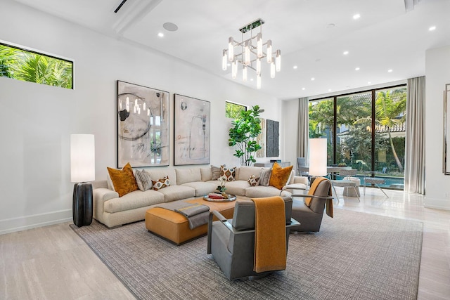 living room with an inviting chandelier and light hardwood / wood-style flooring