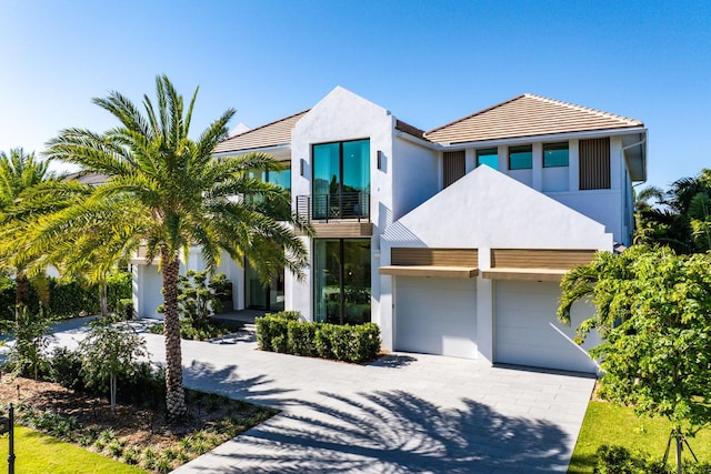 view of front of home featuring a garage and a balcony