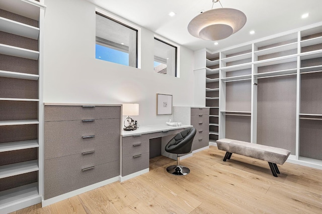 home office with light hardwood / wood-style flooring