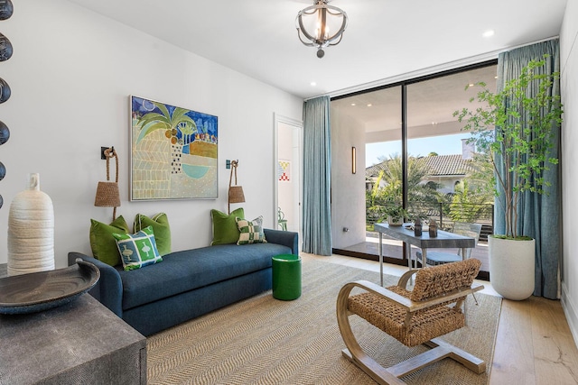 sitting room with light wood-type flooring and expansive windows