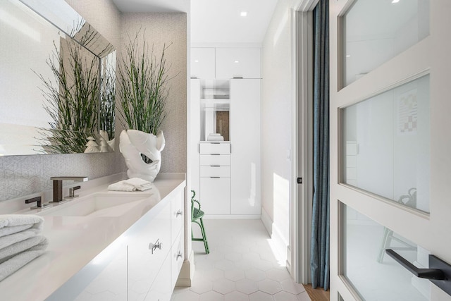 bathroom with tile patterned floors and vanity