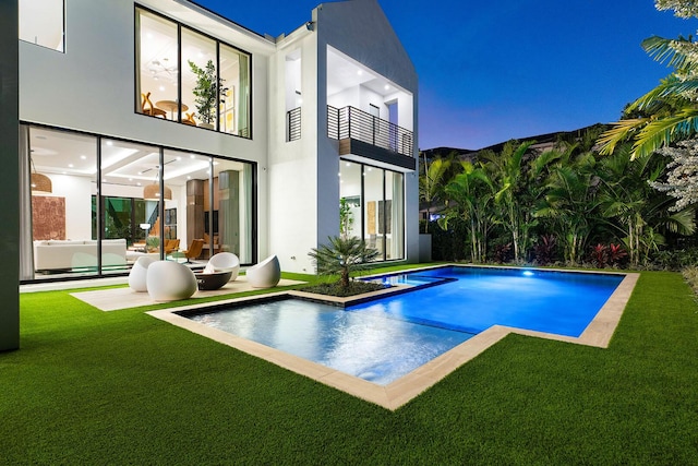 view of pool with an outdoor living space, a yard, and a patio