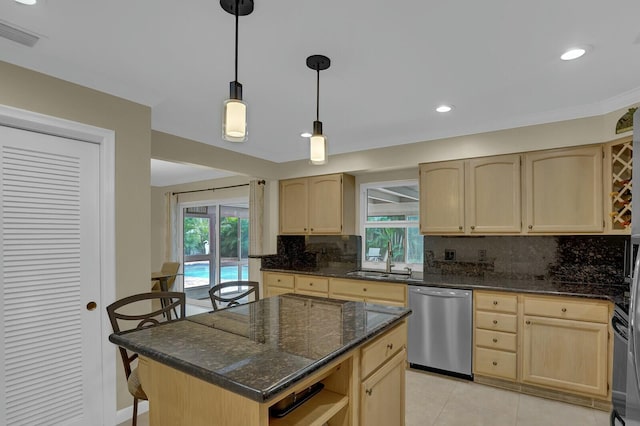 kitchen featuring a center island, light brown cabinets, stainless steel appliances, sink, and light tile patterned floors