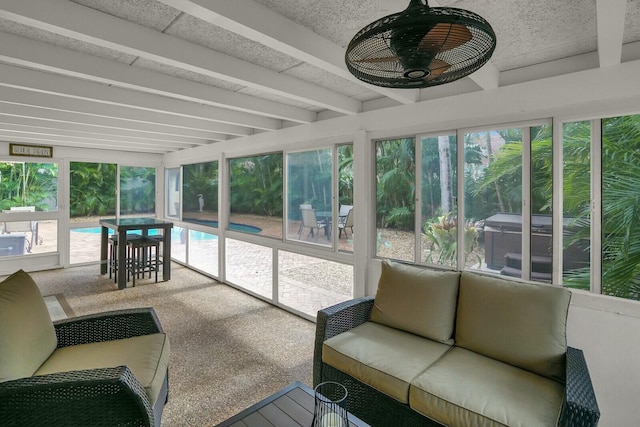 sunroom / solarium featuring ceiling fan, beam ceiling, and a wealth of natural light