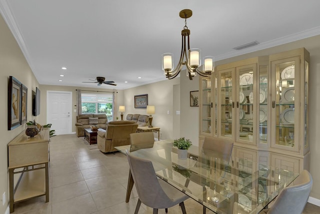 tiled dining space featuring ceiling fan with notable chandelier and ornamental molding