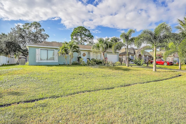 single story home with a garage and a front lawn