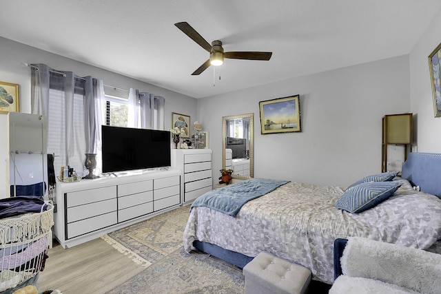 bedroom with ceiling fan and light wood-type flooring