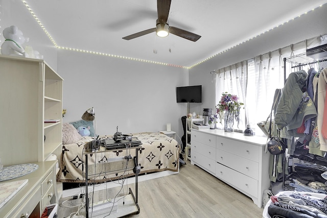 bedroom with ceiling fan and light hardwood / wood-style floors