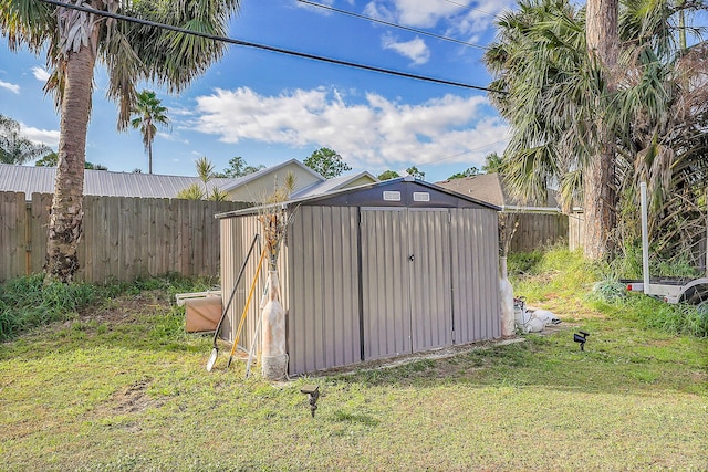 view of outbuilding featuring a lawn