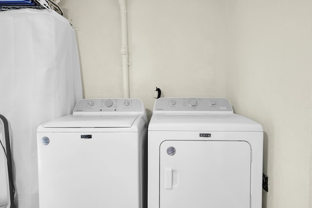 laundry area featuring washing machine and clothes dryer