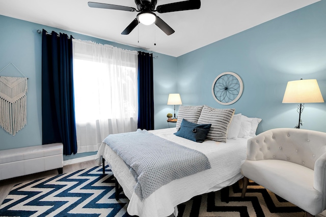 bedroom with wood-type flooring and ceiling fan