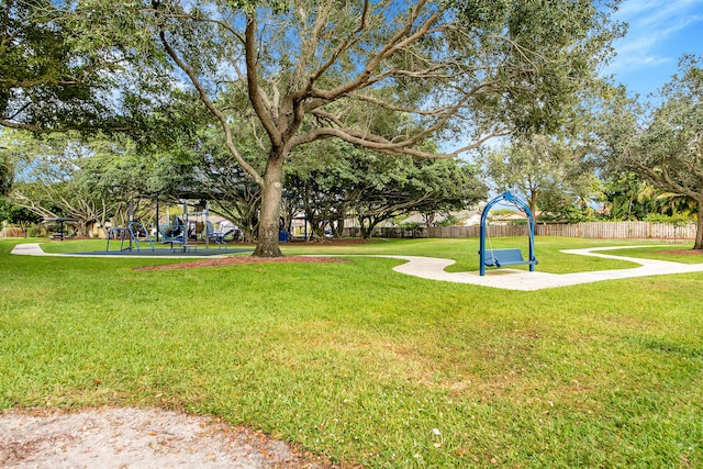 surrounding community featuring a playground and a yard