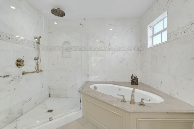 bathroom featuring separate shower and tub and tile walls