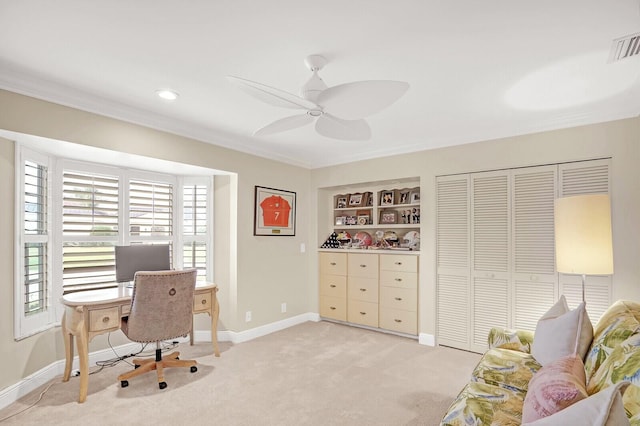 home office featuring light carpet, built in features, ceiling fan, and crown molding