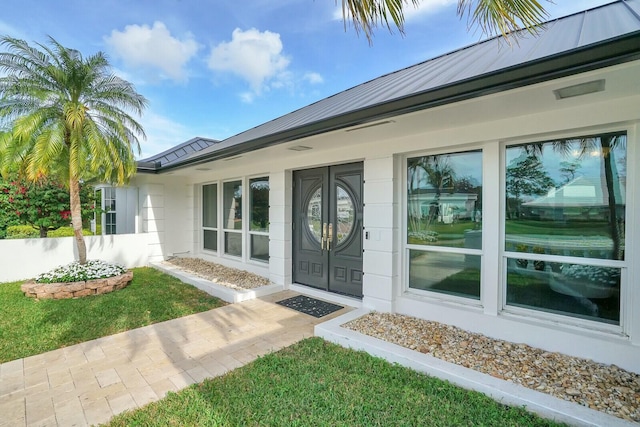 doorway to property featuring a yard