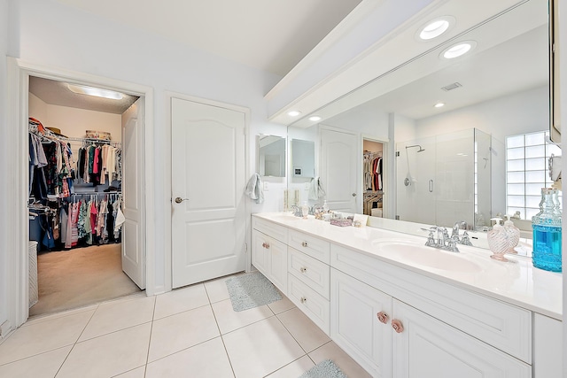 26 Princewood Ln, Palm Beach Gardens, FL 33410 - bathroom with a walk in closet, double vanity, a shower stall, tile patterned flooring, and recessed lighting
