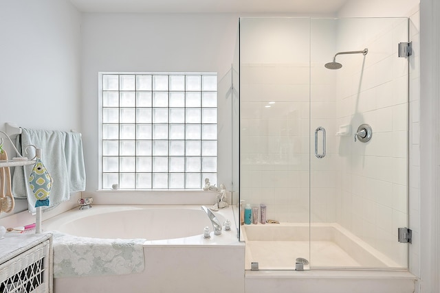 bathroom featuring separate shower and tub