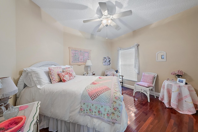 bedroom featuring a textured ceiling, ceiling fan, and dark hardwood / wood-style floors