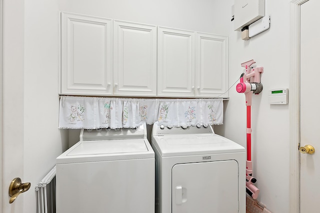 washroom with cabinets and washing machine and clothes dryer