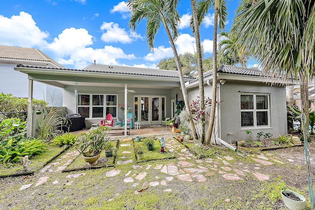 26 Princewood Ln, Palm Beach Gardens, FL 33410 - back of house featuring stucco siding, ceiling fan, a tiled roof, and a patio area