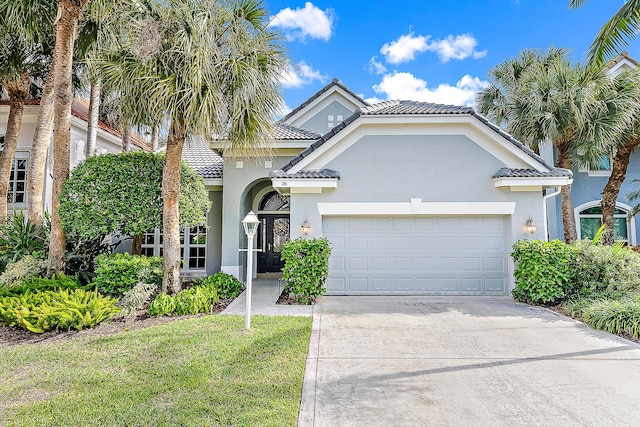 26 Princewood Ln, Palm Beach Gardens, FL 33410 - view of front of home with stucco siding, an attached garage, concrete driveway, a tiled roof, and a front yard