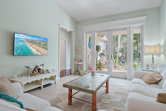 tiled living room with a textured ceiling, french doors, and vaulted ceiling