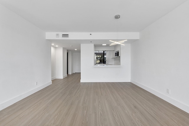 unfurnished living room featuring light hardwood / wood-style floors