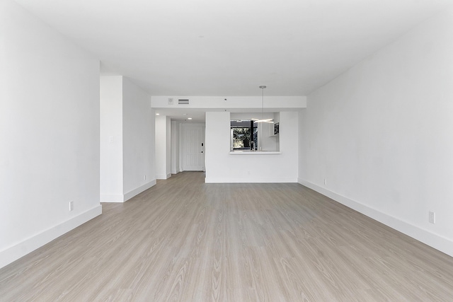 unfurnished room with light wood-type flooring