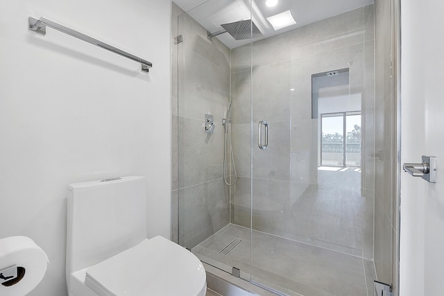 bathroom featuring toilet and an enclosed shower