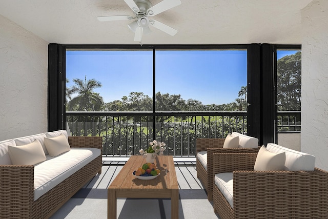 sunroom / solarium featuring ceiling fan and plenty of natural light