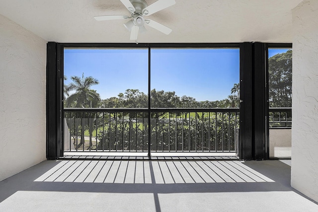 interior space with ceiling fan