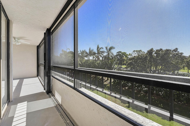 unfurnished sunroom featuring ceiling fan