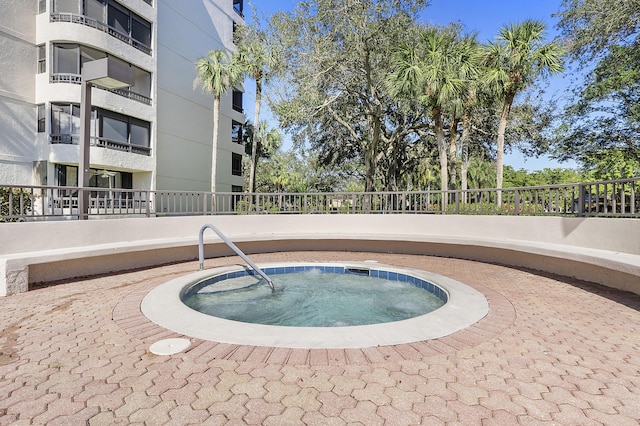 view of pool with a hot tub