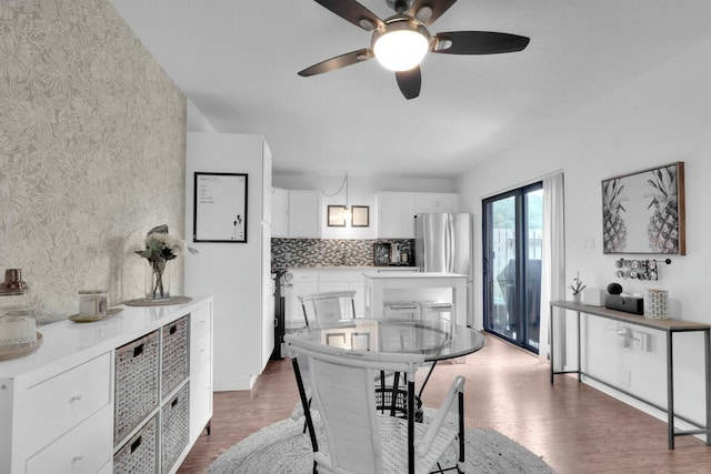 dining room featuring wood-type flooring and ceiling fan