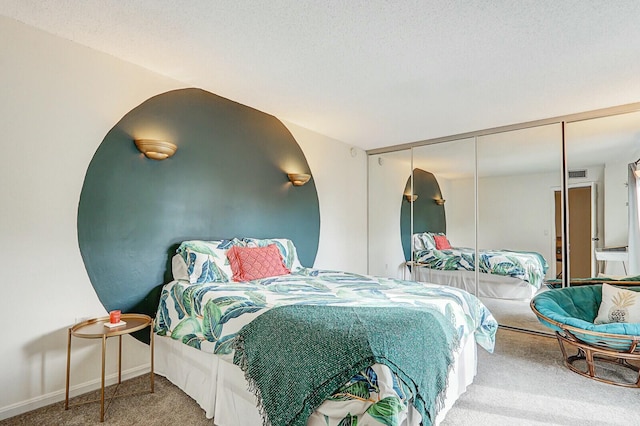 carpeted bedroom featuring a textured ceiling and a closet