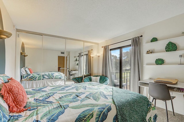 carpeted bedroom featuring a textured ceiling and access to outside