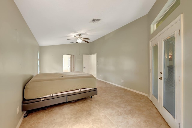 tiled bedroom featuring ceiling fan, lofted ceiling, and french doors