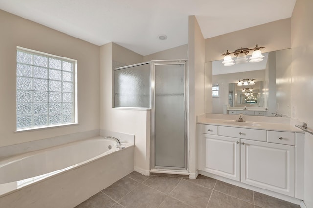 bathroom with tile patterned floors, vanity, and plus walk in shower