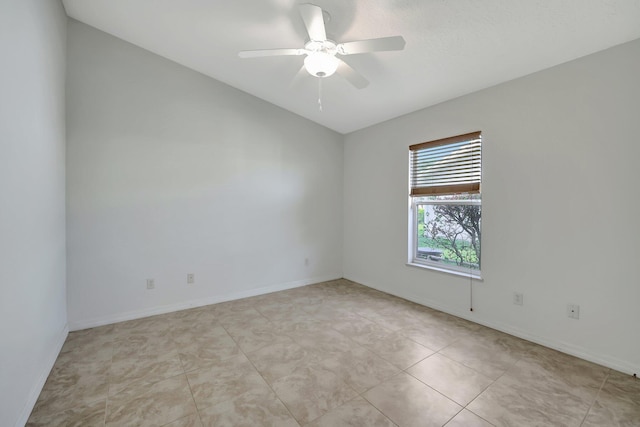 tiled empty room featuring ceiling fan