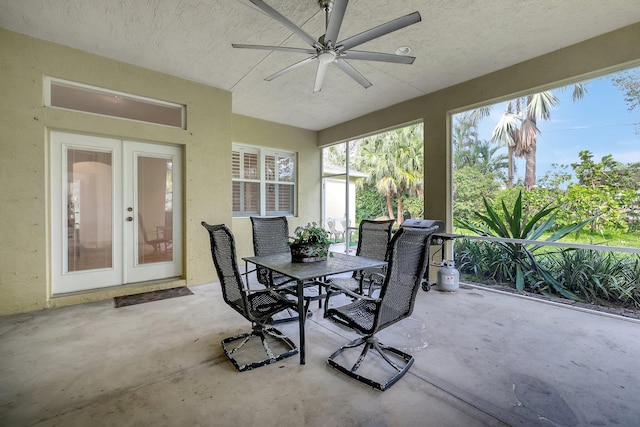 sunroom / solarium featuring ceiling fan and french doors